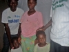 Expectant mother and two children in front of bed with net