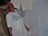 Local volunteer in front of bed with net