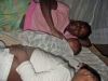 Family sleeping on the bed with net assembled