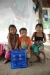 Kids in Sachapapa sit in front of the new net beneath which they will sleep tonight. Since their home has no walls, it affords the only means of protection from mosquitoes.