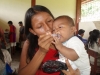 A mother gives her baby the first dose of medication to ward off malaria's worse effects in Ajachim. Education and prevention is given to the people of Peru along with lifesaving bednets.
