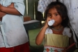 A little girl in Chapis takes her antiparasite medicine in the clinic