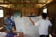 Local Peruvian people are taught how to hang the nets properly as the nets are distributed.
