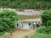 Volunteers make plans after wondering how to get down river to the village of Napruka from the helicopter.