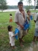 Sloshing through the ankle deep water, a man and his family return home to put up their bednets in Nuevo Alegria.