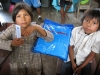 Sister and brother with their newly acquired bednet in Nuevo Alegria.