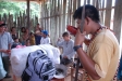 A volunteer drinks masato in Belen with Chief before net distribution as part of welcome ceremony.