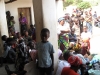 Community members gather in Isanya village to learn about proper betnet use and care while one young boy is more interested in the photographer.