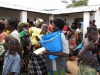 One woman receives her nets while mother and child await theirs. Infants do not have antibodies against malaria infection and are extremely susceptible to infection and death before the age of 5.