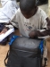 One young man packs his new net in his book bag.