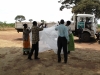 Showing community members how to correctly hang, position, and sleep under their new bednets is imperative to the efficacy of net use.