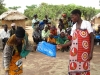 A mother receives a new net which is especially important with an infant. Children under 5 are at highest risk of death.