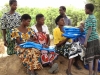 Mothers collect new bednets. Mothers educated on proper net use ensure their children are protected under nets at night.