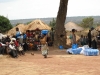 One mother carries child and nets home while other villagers await their new insecticide treated nets.