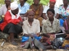 These women look at bednet instructions which show how to hang, clean, and store nets when not in use.