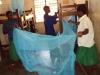 MSIMBATI SEC: Applying the knowledge recently gained, students cooperate tying strings to hang the nets.