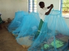 KISIWA SEC: Students work to tie the tops of the LLIN's to the strings provided.