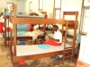 Mtwara Girls - A girl attaches string to her net so she can hang it over her bed.