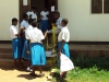 Mustapha Sabodo Sec. - A volunteer passes out rope for students to hang their bed nets.