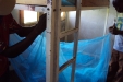 Dodoma School for the Deaf: Caregivers help the young children to install their new mosquito nets.