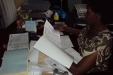 Msalato Girls School: Prior to the caregivers' arrival at Msalato, the headmistress checks the distribution plans.