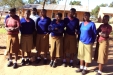 Wottaa - A group of students is educated about malaria and waits to receive new LLINs.