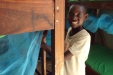 Kigwe Primary: This young man happily installs his new net.