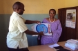 Kigwe Primary: Even the head of the school receives a net as part of the blanket coverage. Children under 5 and pregnant women are at greatest risk for malaria.