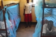 Kigwe Secondary: These girls try out their newly covered bunks. These are some of the lucky children who managed to survive past the age of five. Proper use of bednets can help them be