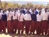 Students gather to be educated on the need for sleeping and resting under an LLIN. They are given instruction on the proper hanging and care of the nets.