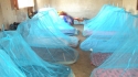 Quickly the students work to hang their nets. They have achieved the opportunity to sleep and rest safe from the malaria ridden mosquito.