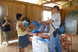 Distributing bednets to a a pregnant women and her young baby--the two most vulnerable groups to devastating malaria illnesses.