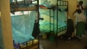 Mbekenyera Sec: Bunk beds are completely covered in mass sleeping areas.