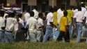 Ruo Sec. School - Students walk to their rooms carrying new LLINs.