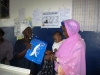Butaw Clinic - mother getting the net from a local volunteer (inside the blue package)