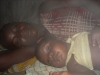 Family sleeping under the mosquito net