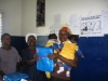 Butaw Clinic - another mother receiving her net (inside the blue package)