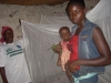 Mother with child in front of bed with net