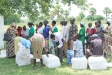 Parish leaders use the packed netting to rest on while waiting for the next group for distribution.