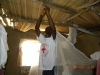 Once again the volunteers begin to educate the villagers as to the proper hanging of the nets.