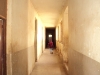 Ndanda Sec. - A young student stands in the bare hallway of his boarding school.