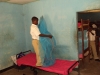 Chidya Sec. - A boy works to hang up his new bed net.