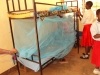 Lukuledi Sec. - A girl makes sure her net is properly fastened to the bed.