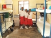 Mtwara Girls - A group of girls stands in their dormitory where the beds were previously not covered by nets.