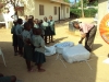 Medi English Medium - A volunteer opens a large pack of nets to distribute them to these children.