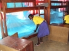 Students at Lulundi Special Primary School help to hang the new bednets in their dormitory.