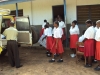 Young women at the Mangaka Secondary school help unload nets that will hang in their boarding school dormitories.