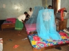 The girls' colorful bedding gets the addition of a blue LLIN to keep them safe from mosquitos at night at Ndwika.