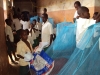 Older students help younger students set up their bednets at the Lukuledi Special Primary School.