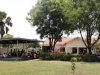 Outside the Teso Safe Motherhood Clinic (TSMC), patients wait in the shade under shelter